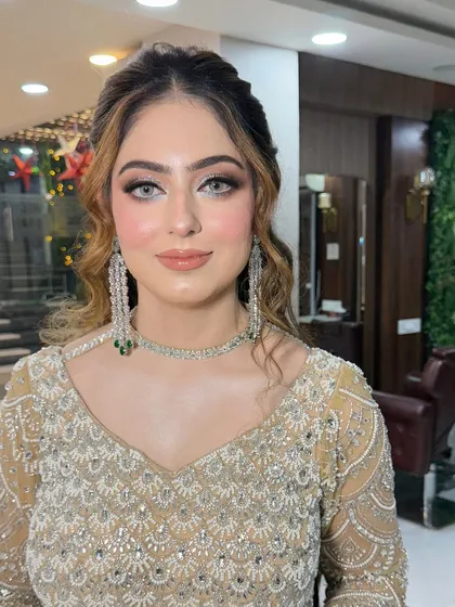 A close-up of this client's beautiful makeup. The look features a soft brown smoky eye and a flawless base, perfect for her golden gown.