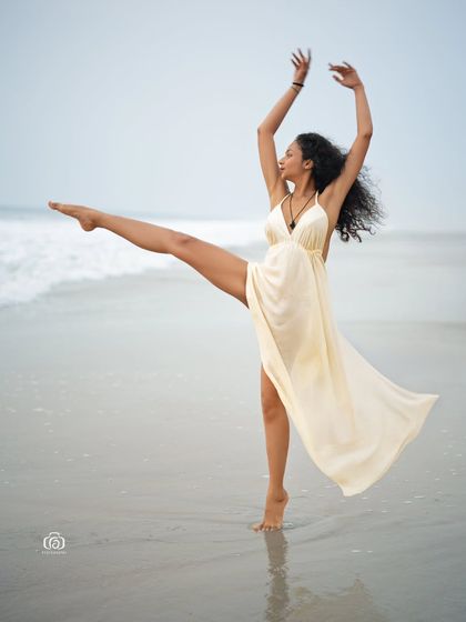 Another beautiful dance pose on the beach, showcasing the model's flexibility and the elegant flow of the white dress. This is a perfect shot for a creative portfolio.