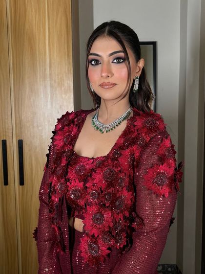 A stunning Roka look for Janvi. The dramatic eye makeup and bold red outfit create a powerful and glamorous statement.