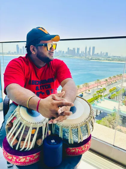 Taking the rhythm international. Here I am with my tablas against the stunning Dubai skyline, always ready for the next gig, wherever it may be.