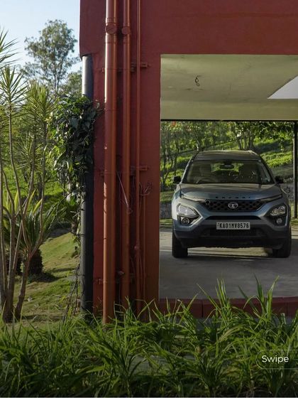 The covered car park is neatly tucked under the main structure of the house, a practical solution that minimizes the building's footprint on the landscape.