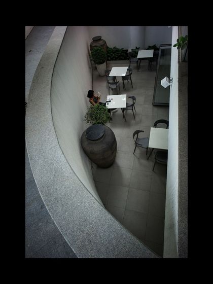 An overhead view of the cafe courtyard, a secluded space designed for quiet contemplation and conversation within the museum complex.