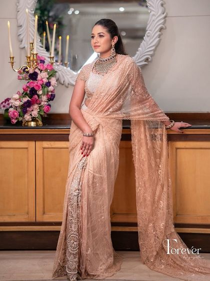 A beautiful sister-of-the-bride look for an engagement, featuring a stunning peach Tarun Tahiliani saree.