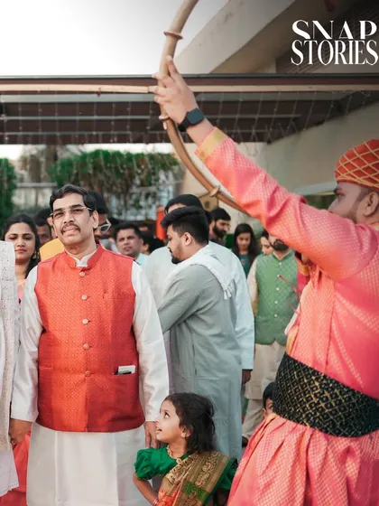 A candid moment during the groom's procession, capturing the expressions of family members. We believe in documenting the reactions of loved ones to tell a fuller story.