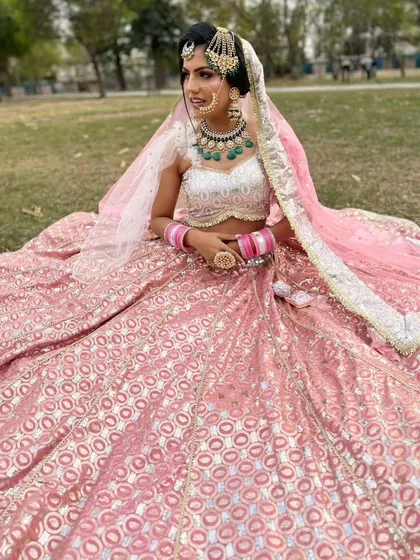 A beautiful pink banarasi lehenga, perfect for a day wedding or as a guest. The fabric has a lovely sheen and the jewellery completes the look.