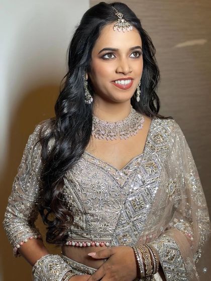 A side profile of the engagement look, showcasing the soft curls and the elegant, understated makeup.