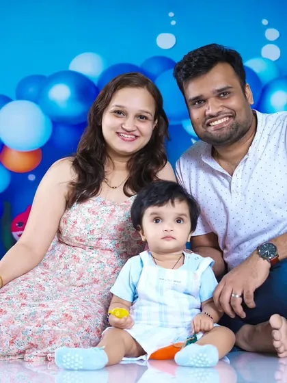 A beautiful family portrait in the middle of the Baby Shark party setup.