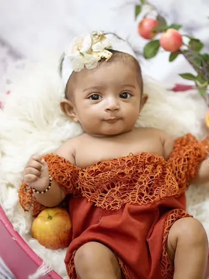 The apple of my eye. This three-month-old baby girl looks adorable in a heart-shaped bowl filled with fresh apples.