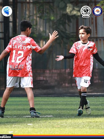 A moment of sportsmanship. A high five between teammates after a good play shows the positive team culture we build.