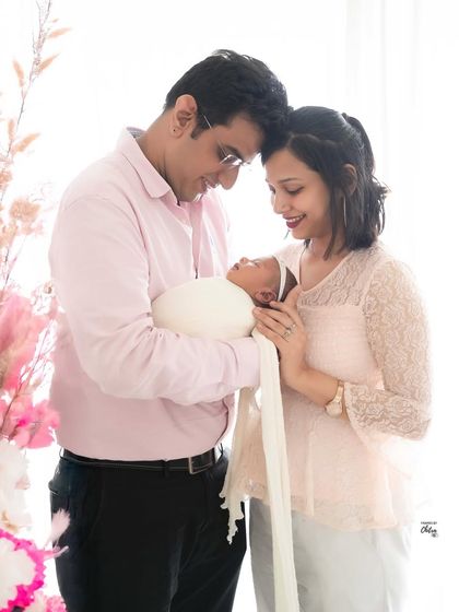 A quiet, tender moment between new parents as they gaze at their baby. These are the unscripted interactions that become your most cherished memories.