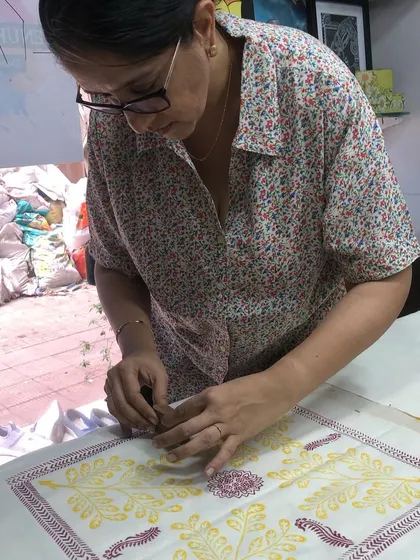 Each print is a moment of creation. This student is building her design element by element, enjoying the meditative rhythm of block printing.