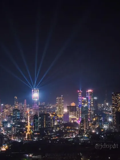 The Mumbai skyline is lit up for Diwali, with the Palais Royale's spotlights shining into the colorful night sky.