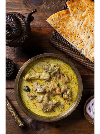 Hyderabadi Mutton Marag, a delicate mutton stew, served with Taftan bread. This top-down shot for The Nawaab's shows the complete dish as it would be served.