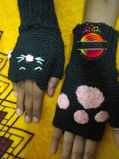 Keep your hands warm with these playful cat paw fingerless gloves. They are designed with a cute cat face on one hand and pink paw pads on the other, perfect for cat lovers.