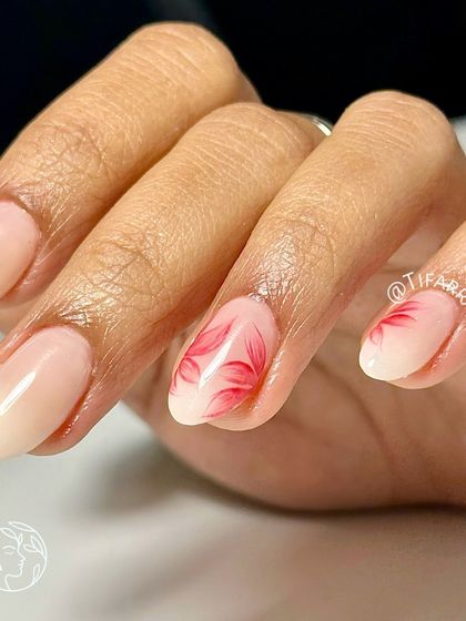 A close-up of the hand-painted red floral art, showing the delicate, translucent petals.