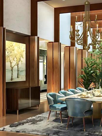 We believe in designing the "in-between" spaces with intention. This elegant dining area, with its rich wood paneling and sophisticated blue chairs, shows how transitional zones can be crafted to become memorable destinations in their own right.