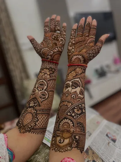 This design features a mix of bold tribal-inspired motifs and delicate traditional patterns.