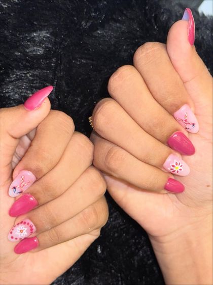 Get ready for Garba with these Navratri-inspired nails. This festive set features a vibrant pink base with intricate, traditional patterns hand-painted in white.