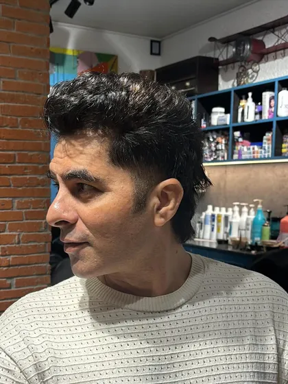 A burst fade is a great way to add a creative touch to a men's cut. The fade is concentrated around the ear, creating a semi-circular or 'burst' effect that looks great with shorter, textured styles.