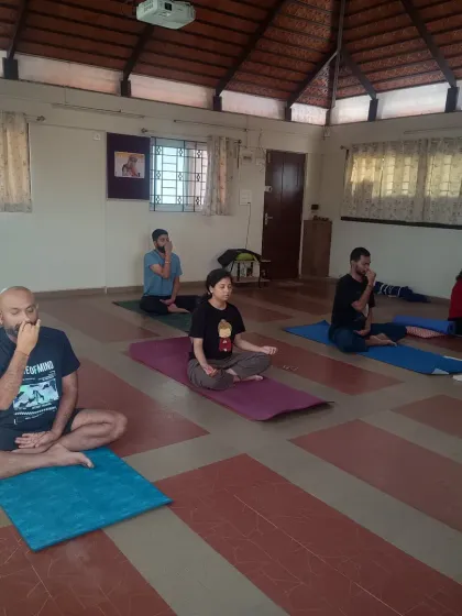 Participants practicing Nadi Shuddhi pranayama during a session. This breathing technique helps to balance the system and calm the mind. It is an essential part of our practice to prepare the inner environment for deeper states of meditation.