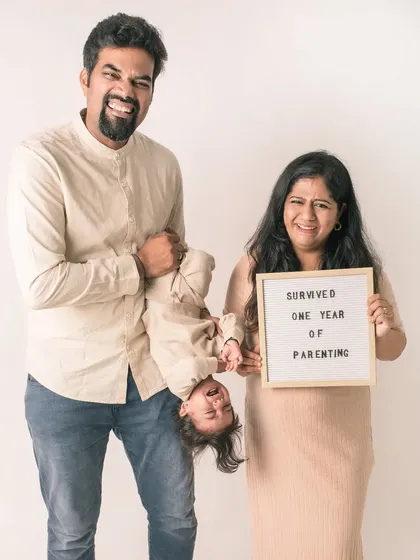 "Survived one year of parenting!" This fun and honest family portrait brings a touch of humor to the beautiful chaos of raising a child.
