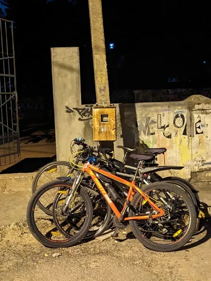 A simple stack of three bikes against a gate. This was after we dropped a new member home, a perfect end to a night of community and cycling.