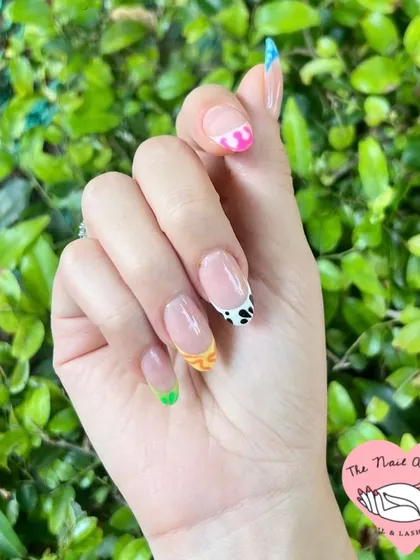 Another view of the fun and colorful animal print French manicure, perfect for expressing your personality.