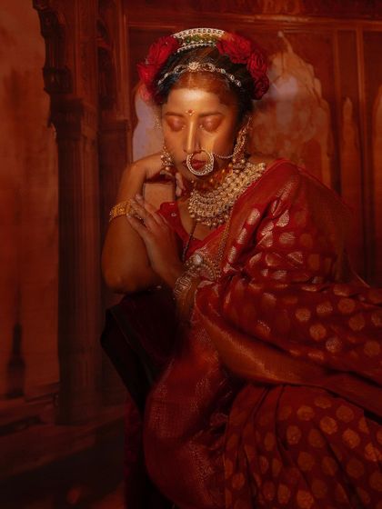 A moody and artistic shot of Ketaki Narayan, with the shadows adding depth to her dramatic red Banarsi saree look.