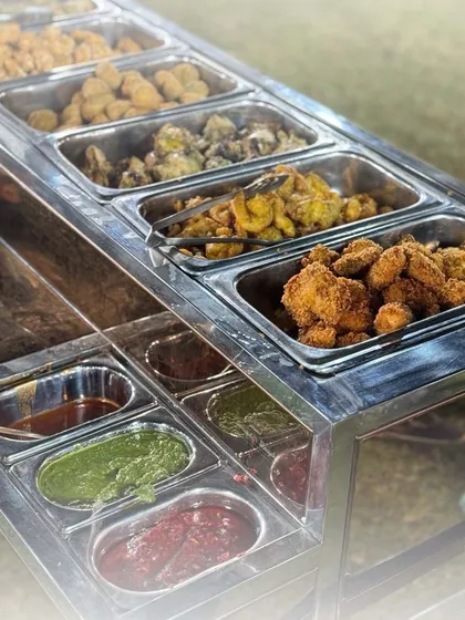 Our starter trolley offers a fantastic variety of hot appetizers and accompanying chutneys. This setup allows guests to sample a wide range of our delicious creations.
