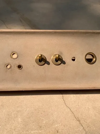 The stone version of the custom switch plate. The more rustic, earthy quality of the stone gives the same design a completely different character, tailored to its specific location within the house.