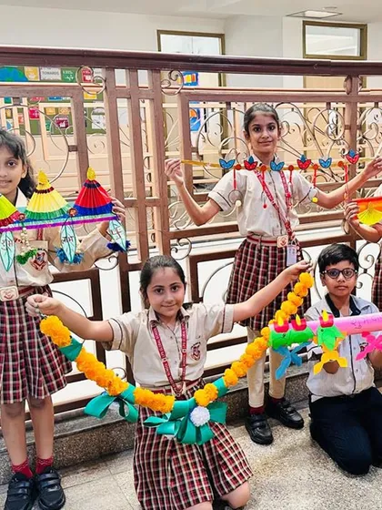 Students pose with their handmade Diwali decorations, including intricate torans and garlands. These activities help develop their artistic skills and an appreciation for traditional crafts.