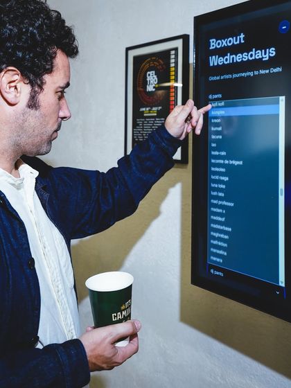 A visitor explores an interactive screen displaying the extensive artist list from Boxout Wednesdays. This highlights the sheer volume and diversity of talent we've hosted over the years.