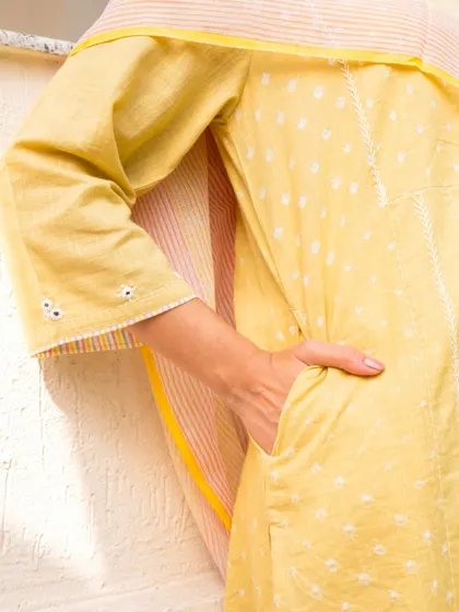 Pockets are a standard for us. This detail shot of our yellow Suhani kurta highlights the practical side pocket, seamlessly integrated into the design for everyday convenience.