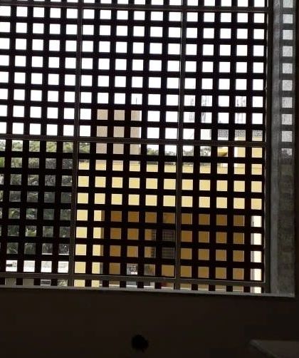 A Tipwood screen used as a 'jaali' or lattice. This provides security and ventilation for a window opening while creating an interesting visual element on the facade.