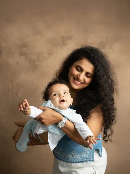 A playful moment, with mom lifting her baby up as if in flight. These interactive shots result in the most natural smiles and laughter.