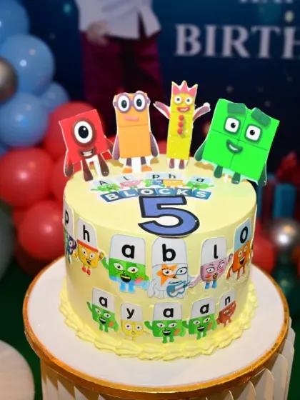 A detailed look at the Alphablocks-themed cake. The cake is decorated with characters from the show, making it a highlight for the kids at the party.