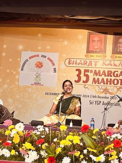 A vibrant photo from the 35th Margazhi Mahotsav by Bharat Kalachar. The colorful stage and my joyful expression reflect the festive spirit of the season.