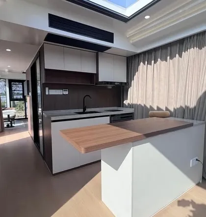 Another view of the well-appointed kitchenette and living area in the Space Capsule E8. The design prioritizes both functionality and a high-end aesthetic.