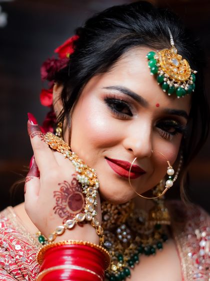 A close-up that highlights the intricate details of the henna and the hand jewelry.