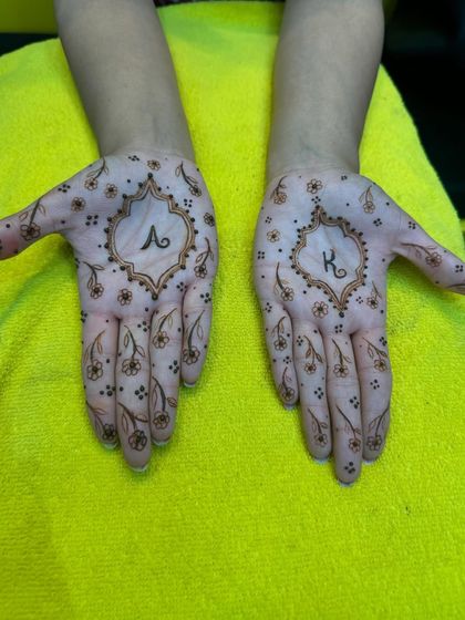 A delicate and charming design featuring the initials 'A' and 'K' surrounded by tiny flowers. A lovely option for couples or engagements.