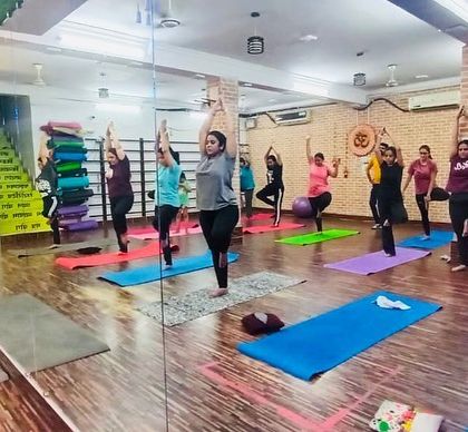 A wide view of our yoga session in progress. You can see the supportive environment where everyone works at their own pace.