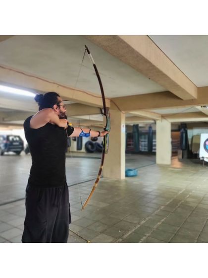 An archer with a strong, steady form. We work on building core and back strength to support this posture.