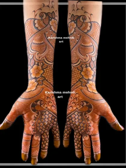 This is a perfect example of intricate mehendi for guests, often called 'siders work'. This design features symmetrical peacocks and detailed patterns, offering a rich, full-hand look for bridesmaids and close family.