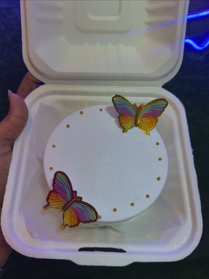 A minimalist bento cake with delicate, rainbow-colored butterflies. This design is simple, elegant, and perfect for someone who appreciates subtle beauty.