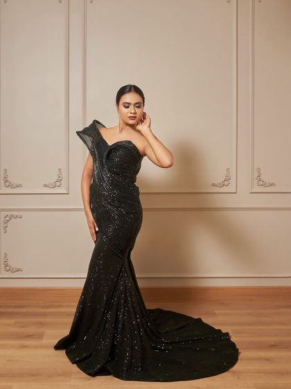 A full-length shot of the 'Fantasia' gown, showing off its flattering mermaid silhouette and the elegant train.
