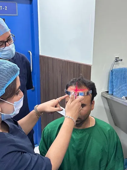 Precision is key. In this photo from a live workshop, I am demonstrating how to accurately mark the hairline, a critical first step for a natural-looking hair transplant.