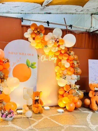 The full backdrop for the teddy bear and orange themed baby shower, complete with custom signage and props.