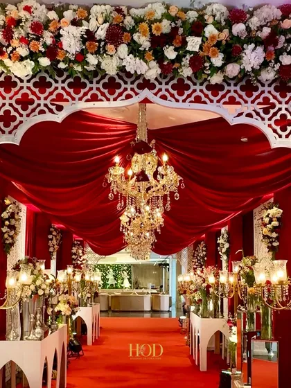 Color and texture can completely transform a space. I used rich red velvet drapes and magnificent crystal chandeliers to create this dramatic and royal entrance aisle, ensuring a grand and memorable welcome for every guest.