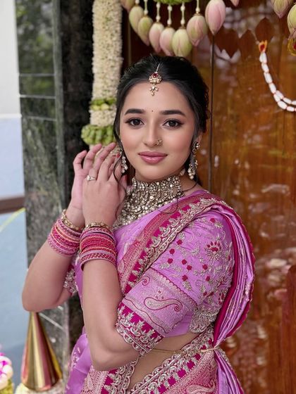A vision in pink for a bangle ceremony, this look is minimal yet majestic with dewy makeup and a statement choker.