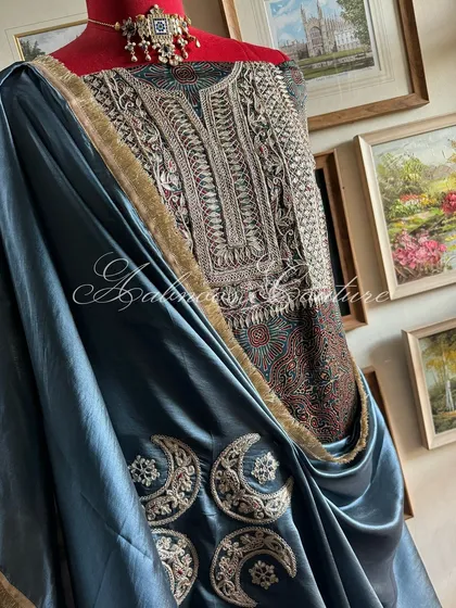 This view captures the elegant silhouette created by the draped dupatta against the structured kurta, perfect for a statement appearance.